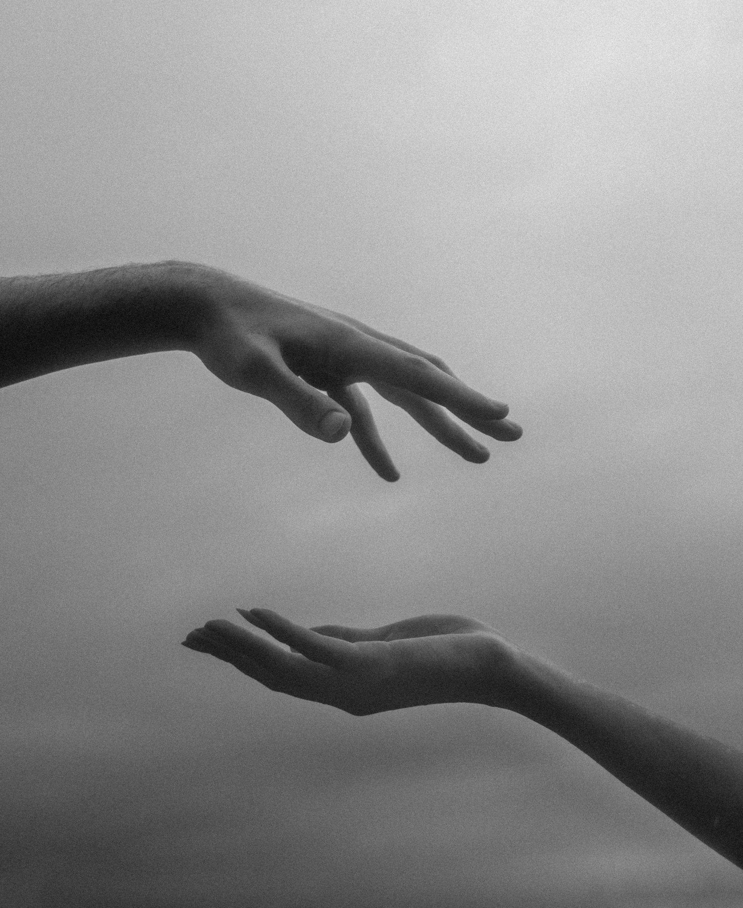 Hands reaching towards one another